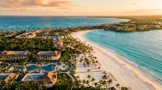 Aerial view of pristine Caribbean beach with multiple luxury resorts and turquoise waters