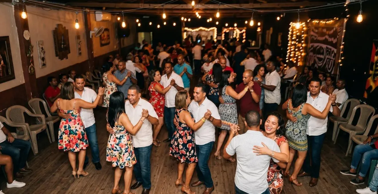 Multiple couples dancing merengue in a vibrant Dominican party setting