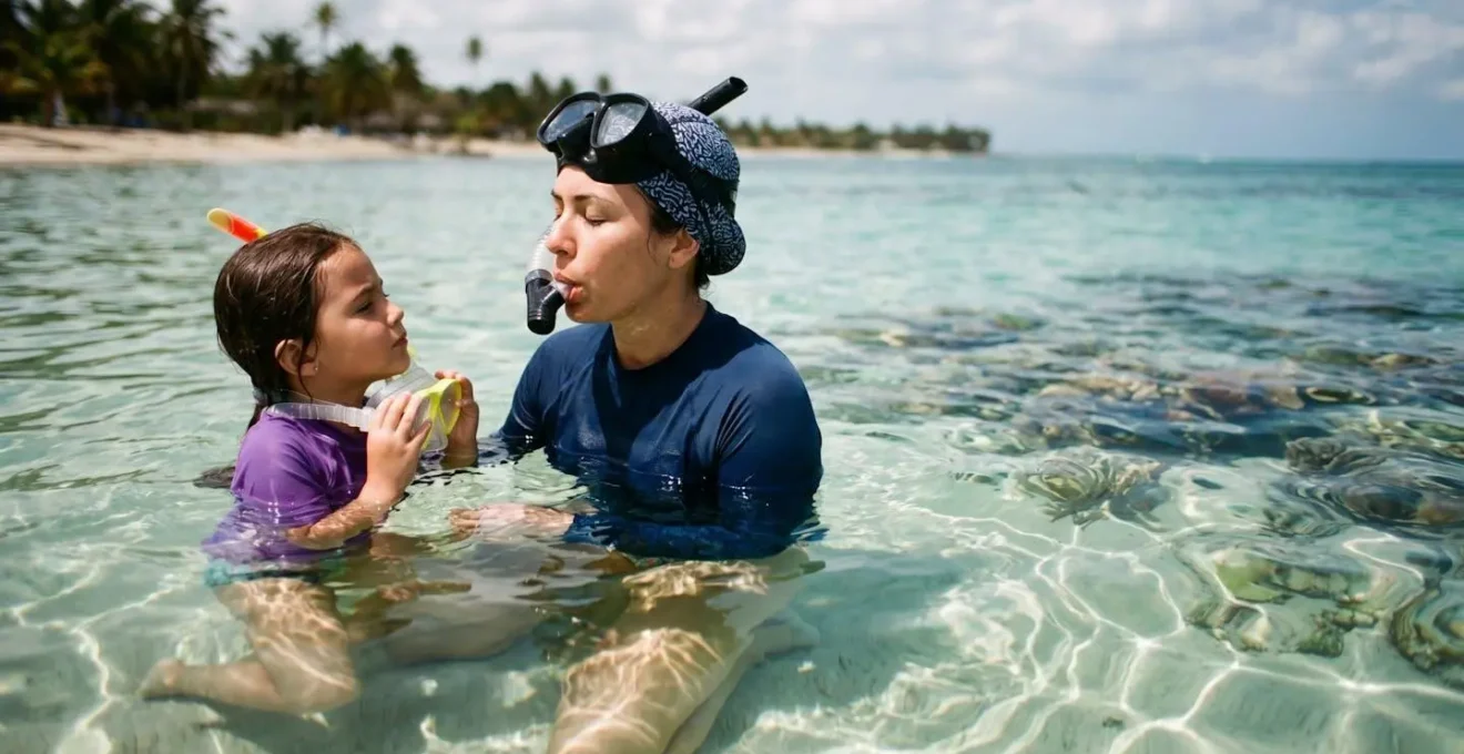 Adult demonstrating proper breathing technique with traditional snorkel mask in crystal clear shallow water