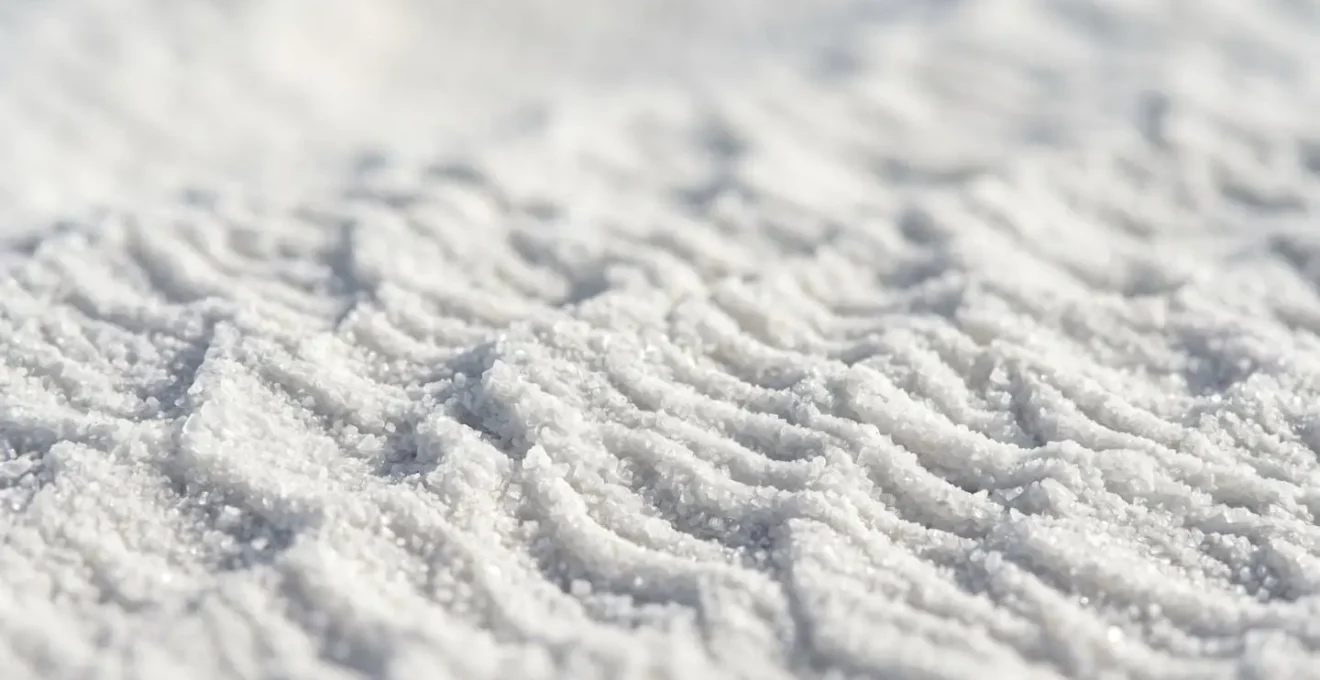 Close-up macro view of pristine white sand ripples showing texture detail and subtle shadows